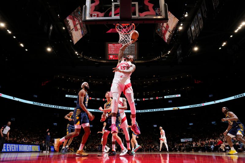 TORONTO, CANADA - APRIL 9: Christian Koloko #35 of the Toronto Raptor drives to the basket during the game against the Indiana Pacers on April 9, 2024 at the Scotiabank Arena in Toronto, Ontario, Canada.  NOTE TO USER: User expressly acknowledges and agrees that, by downloading and or using this Photograph, user is consenting to the terms and conditions of the Getty Images License Agreement.  Mandatory Copyright Notice: Copyright 2024 NBAE (Photo by Mark Blinch/NBAE via Getty Images)