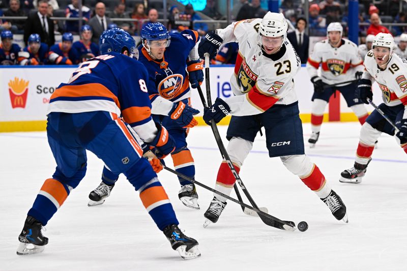 Oct 26, 2024; Elmont, New York, USA;  New York Islanders defenseman Noah Dobson (8) blocks the shot by Florida Panthers center Carter Verhaeghe (23) during the third period at UBS Arena. Mandatory Credit: Dennis Schneidler-Imagn Images