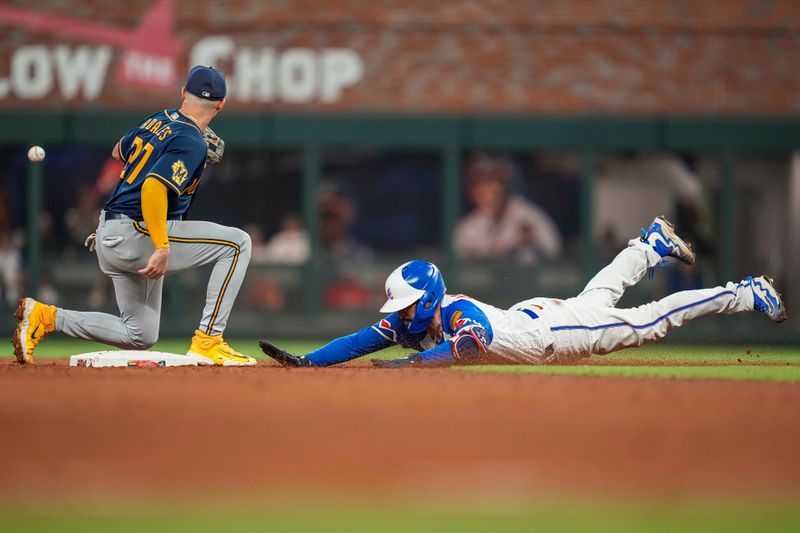 Jul 29, 2023; Cumberland, Georgia, USA; Atlanta Braves catcher Travis d'Arnaud (16) dives into second base under Milwaukee Brewers shortstop Willy Adames (27) after hitting a double during the seventh inning at Truist Park. Mandatory Credit: Dale Zanine-USA TODAY Sports