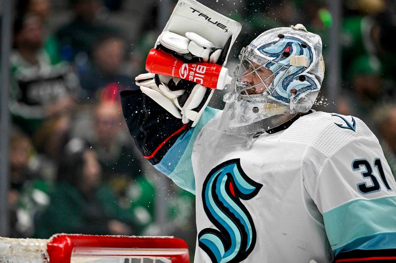 May 15, 2023; Dallas, Texas, USA; Seattle Kraken goaltender Philipp Grubauer (31) sprays his face with water during a stoppage in play during the second period against the Dallas Stars in game seven of the second round of the 2023 Stanley Cup Playoffs at the American Airlines Center. Mandatory Credit: Jerome Miron-USA TODAY Sports