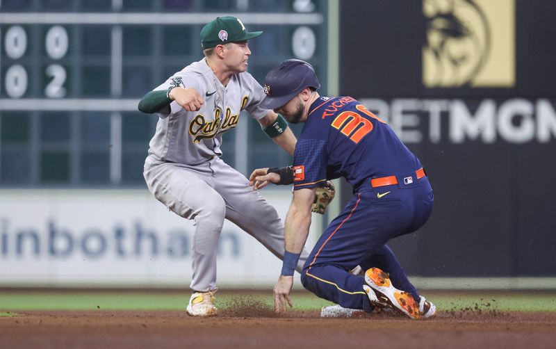 Sep 11, 2023; Houston, Texas, USA; Houston Astros right fielder Kyle Tucker (30) is tagged out by Oakland Athletics shortstop Nick Allen (2) on a pickoff play during the fourth inning at Minute Maid Park. Mandatory Credit: Troy Taormina-USA TODAY Sports