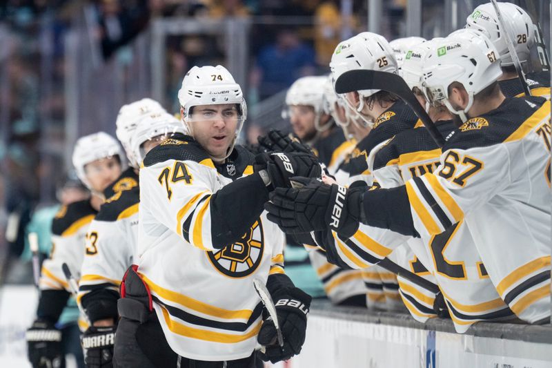 Feb 23, 2023; Seattle, Washington, USA; Boston Bruins forward Jake DeBrusk (74) is congratulated by teammates on the bench during the third period against the Seattle Kraken at Climate Pledge Arena. Mandatory Credit: Stephen Brashear-USA TODAY Sports