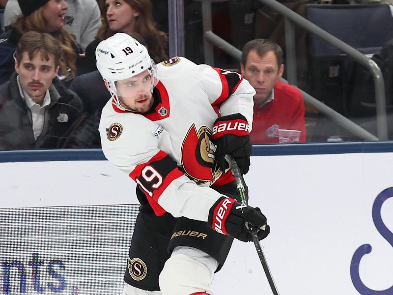 Dec 11, 2025; Columbus, Ohio, USA; Ottawa Senators right wing Drake Batherson (19) passes the puck as Columbus Blue Jackets defenseman Denton Mateychuk (5) defends during the first period at Nationwide Arena. Mandatory Credit: Joseph Maiorana-Imagn Images