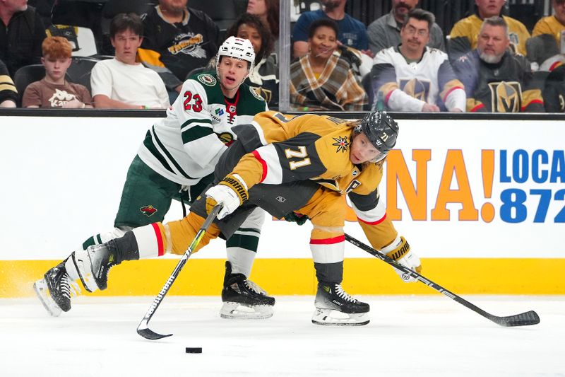 Apr 12, 2024; Las Vegas, Nevada, USA; Vegas Golden Knights center William Karlsson (71) skates the puck away from Minnesota Wild center Marco Rossi (23) during the first period at T-Mobile Arena. Mandatory Credit: Stephen R. Sylvanie-USA TODAY Sports