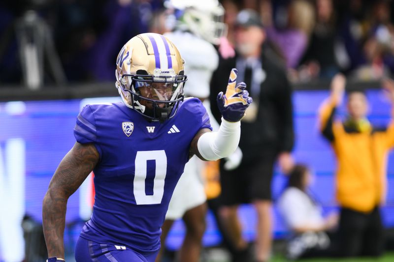 Oct 14, 2023; Seattle, Washington, USA; Washington Huskies wide receiver Giles Jackson (0) celebrates after scoring a touchdown against the Oregon Ducks during the first half at Alaska Airlines Field at Husky Stadium. Mandatory Credit: Steven Bisig-USA TODAY Sports