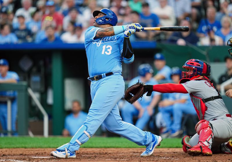 Aug 11, 2023; Kansas City, Missouri, USA; Kansas City Royals catcher Salvador Perez (13) hits a home run against the St. Louis Cardinals during the second inning at Kauffman Stadium. Mandatory Credit: Jay Biggerstaff-USA TODAY Sports