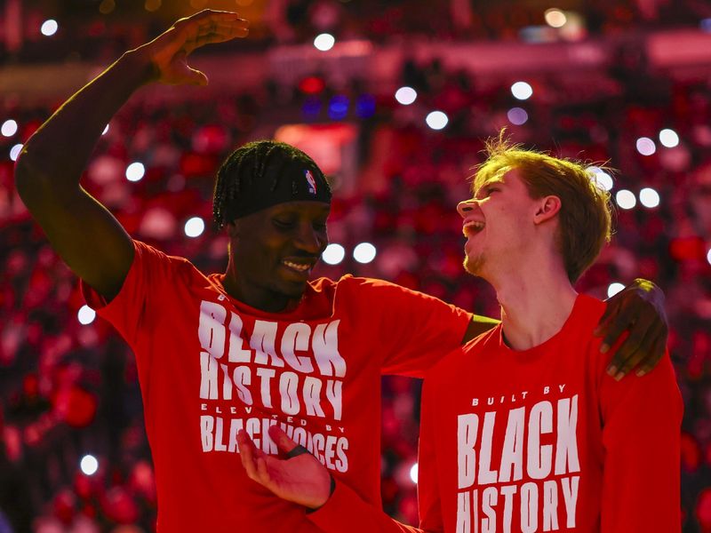 TORONTO, CANADA - FEBRUARY 22: Chris Boucher #25 and Gradey Dick #1 of the Toronto Raptors are introduced before the game against the Brooklyn Nets on February 22, 2024 at the Scotiabank Arena in Toronto, Ontario, Canada.  NOTE TO USER: User expressly acknowledges and agrees that, by downloading and or using this Photograph, user is consenting to the terms and conditions of the Getty Images License Agreement.  Mandatory Copyright Notice: Copyright 2024 NBAE (Photo by Vaughn Ridley/NBAE via Getty Images)