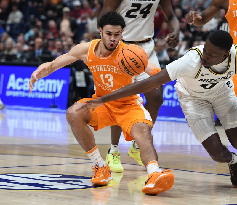 Mar 10, 2023; Nashville, TN, USA; Tennessee Volunteers forward Olivier Nkamhoua (13) loses the ball against Missouri Tigers forward Mohamed Diarra (0) during the second half at Bridgestone Arena. Mandatory Credit: Christopher Hanewinckel-USA TODAY Sports