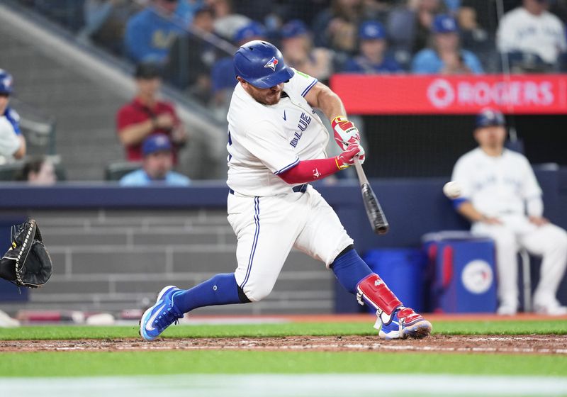 Apr 15, 2024; Toronto, Ontario, CAN; Toronto Blue Jays catcher Alejandro Kirk wearing number 42 for Jackie Robinson Day hits a single against the New York Yankees during the sixth inning at Rogers Centre. Mandatory Credit: Nick Turchiaro-USA TODAY Sports