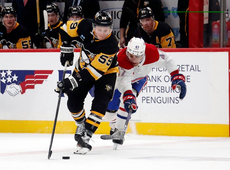 Jan 27, 2024; Pittsburgh, Pennsylvania, USA;  Pittsburgh Penguins left wing Jake Guentzel (59) moves the puck against Montreal Canadiens defenseman Jayden Struble (47) during the third period at PPG Paints Arena. The Penguins won 3-2 in overtime.Mandatory Credit: Charles LeClaire-USA TODAY Sports