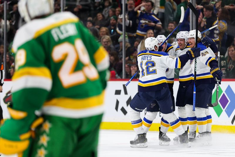 Mar 23, 2024; Saint Paul, Minnesota, USA; St. Louis Blues players celebrate the win as Minnesota Wild goaltender Marc-Andre Fleury (29) skates off the ice during overtime at Xcel Energy Center. Mandatory Credit: Matt Krohn-USA TODAY Sports