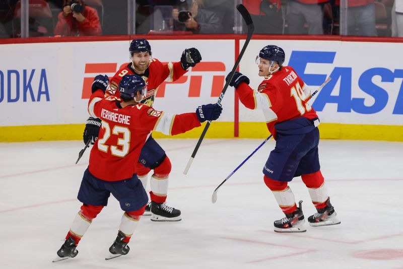 Apr 21, 2024; Sunrise, Florida, USA; Florida Panthers left wing Matthew Tkachuk (19) celebrates with center Carter Verhaeghe (23) and center Sam Bennett (9) after scoring against the Tampa Bay Lightning during the third period in game one of the first round of the 2024 Stanley Cup Playoffs at Amerant Bank Arena. Mandatory Credit: Sam Navarro-USA TODAY Sports