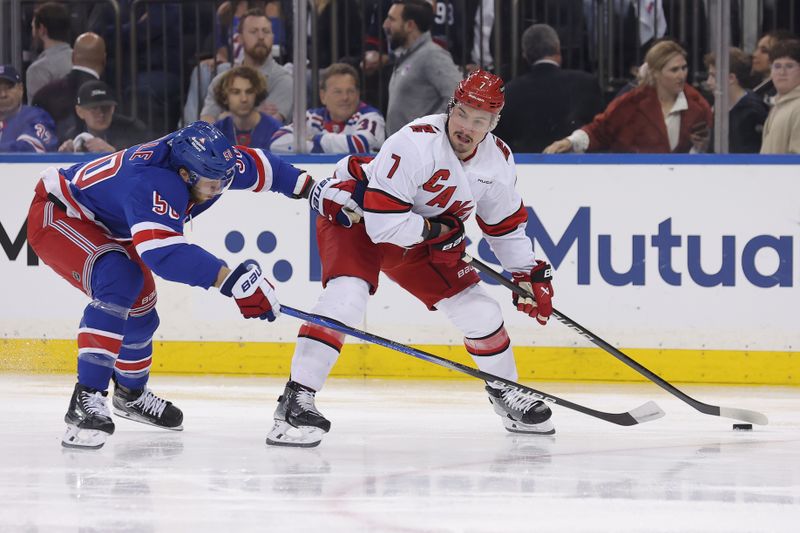 May 13, 2024; New York, New York, USA; Carolina Hurricanes defenseman Dmitry Orlov (7) controls the puck against New York Rangers left wing Will Cuylle (50) during the first period of game five of the second round of the 2024 Stanley Cup Playoffs at Madison Square Garden. Mandatory Credit: Brad Penner-USA TODAY Sports