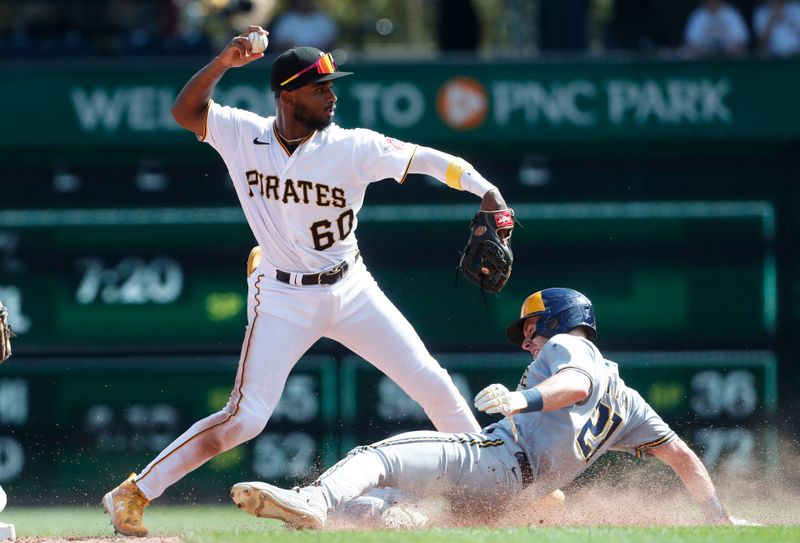 Sep 6, 2023; Pittsburgh, Pennsylvania, USA;  Pittsburgh Pirates shortstop Liover Peguero (60) throws to first base to complete  double play over Milwaukee Brewers right fielder Mark Canha (21) to end the eighth inning at PNC Park. Pittsburgh won 5-4. Mandatory Credit: Charles LeClaire-USA TODAY Sports