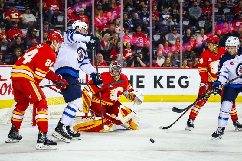 Oct 3, 2025; Calgary, Alberta, CAN; Calgary Flames goaltender Dustin Wolf (32) guards his net against the Winnipeg Jets during the first period at Scotiabank Saddledome. Mandatory Credit: Sergei Belski-Imagn Images