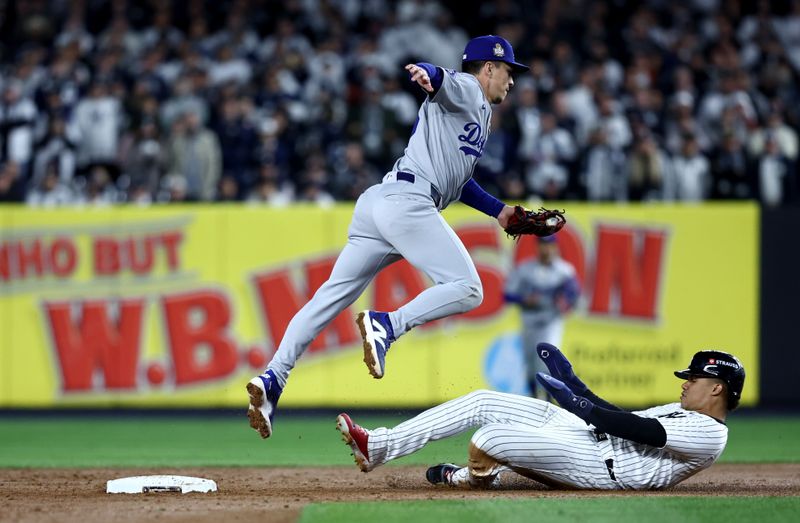 Oct 28, 2024; New York, New York, USA; Los Angeles Dodgers outfielder Tommy Edman (25) forces out New York Yankees outfielder Juan Soto (22) during the sixth inning in game three of the 2024 MLB World Series at Yankee Stadium. Mandatory Credit: Wendell Cruz-Imagn Images