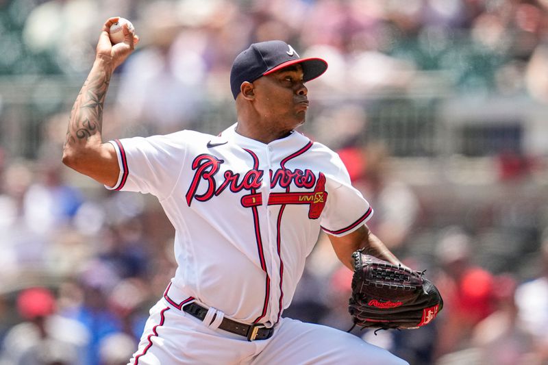 Jun 28, 2023; Cumberland, Georgia, USA; Atlanta Braves relief pitcher Raisel Iglesias (26) pitches against the Minnesota Twins during the ninth inning at Truist Park. Mandatory Credit: Dale Zanine-USA TODAY Sports