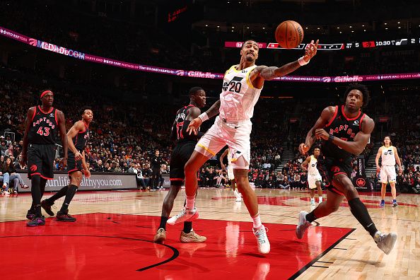 TORONTO, CANADA - DECEMBER 23:  John Collins #20 of the Utah Jazz reaches for the ball during the game against the Toronto Raptors on December 23, 2023 at the Scotiabank Arena in Toronto, Ontario, Canada.  NOTE TO USER: User expressly acknowledges and agrees that, by downloading and or using this Photograph, user is consenting to the terms and conditions of the Getty Images License Agreement.  Mandatory Copyright Notice: Copyright 2023 NBAE (Photo by Vaughn Ridley/NBAE via Getty Images)