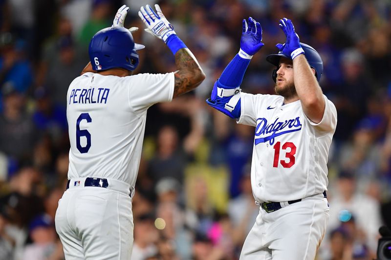 Jul 24, 2023; Los Angeles, California, USA; Los Angeles Dodgers designated hitter Max Muncy (13) is greeted by left fielder David Peralta (6) after hitting a solo home run against the Toronto Blue Jays during the eighth inning at Dodger Stadium. Mandatory Credit: Gary A. Vasquez-USA TODAY Sports