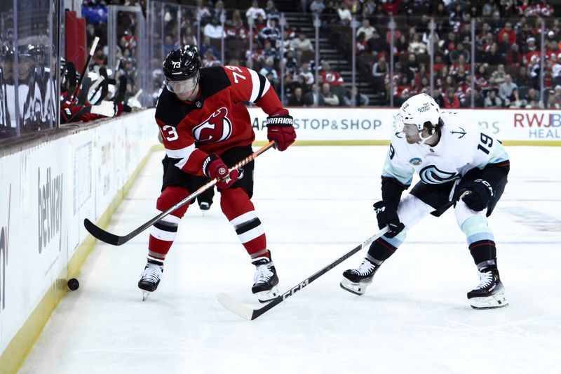 Feb 12, 2024; Newark, New Jersey, USA; New Jersey Devils right wing Tyler Toffoli (73) skates with the puck against Seattle Kraken left wing Jared McCann (19) during the second period at Prudential Center. Mandatory Credit: John Jones-USA TODAY Sports