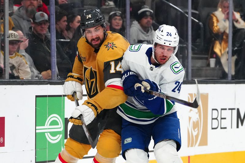 Mar 7, 2024; Las Vegas, Nevada, USA; Vegas Golden Knights defenseman Nicolas Hague (14) checks Vancouver Canucks center Pius Suter (24) during the first period at T-Mobile Arena. Mandatory Credit: Stephen R. Sylvanie-USA TODAY Sports