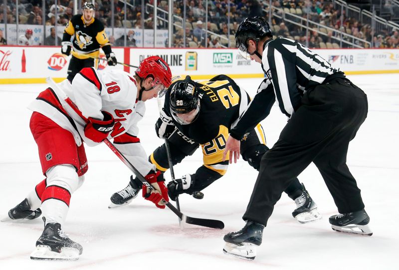 Oct 18, 2024; Pittsburgh, Pennsylvania, USA; Carolina Hurricanes center Jack Drury (18) and Pittsburgh Penguins center Lars Eller (20) take a face-off during the third period at PPG Paints Arena. Mandatory Credit: Charles LeClaire-Imagn Images