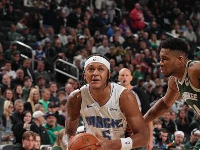 MILWAUKEE, WI - DECEMBER 21:  Paolo Banchero #5 of the Orlando Magic drives to the basket during the game against the Milwaukee Bucks  on December 21, 2023 at the Fiserv Forum Center in Milwaukee, Wisconsin. NOTE TO USER: User expressly acknowledges and agrees that, by downloading and or using this Photograph, user is consenting to the terms and conditions of the Getty Images License Agreement. Mandatory Copyright Notice: Copyright 2023 NBAE (Photo by Gary Dineen/NBAE via Getty Images).