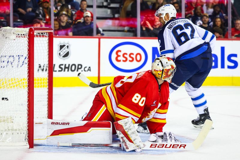 Oct 4, 2024; Calgary, Alberta, CAN; Winnipeg Jets right wing Nino Niederreiter (62) scores a goal against Calgary Flames goaltender Dan Vladar (80) during the first period at Scotiabank Saddledome. Mandatory Credit: Sergei Belski-Imagn Images