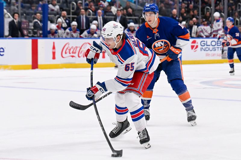 Apr 10, 2025; Elmont, New York, USA;  New York Rangers left wing Brett Berard (65) attempts a shot against the New York Islanders during the first period at UBS Arena. Mandatory Credit: Dennis Schneidler-Imagn Images