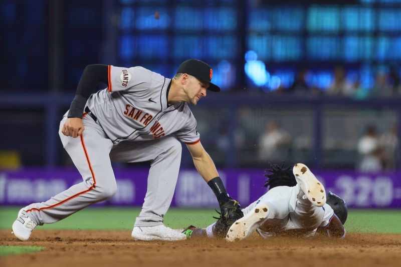 Apr 17, 2024; Miami, Florida, USA; San Francisco Giants shortstop Nick Ahmed (16) tags out Miami Marlins center fielder Jazz Chisholm Jr. (2) at second base during the sixth inning at loanDepot Park. Mandatory Credit: Sam Navarro-USA TODAY Sports