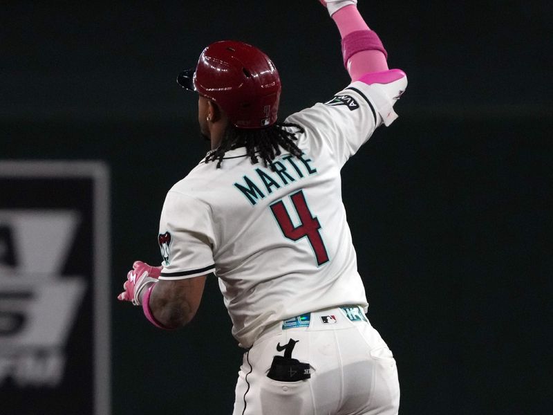 May 18, 2025; Phoenix, Arizona, USA; Arizona Diamondbacks second base Ketel Marte (4) hits a solo home run against the Colorado Rockies in the first inning at Chase Field. Mandatory Credit: Rick Scuteri-Imagn Images
