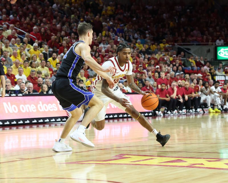 Mar 6, 2024; Ames, Iowa, USA; Brigham Young Cougars guard Tanner Hayhurst (24) defends Iowa State Cyclones guard Keshon Gilbert (10) at James H. Hilton Coliseum. Mandatory Credit: Reese Strickland-USA TODAY Sports