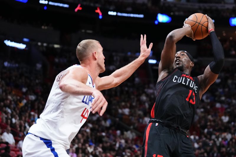 MIAMI, FLORIDA - FEBRUARY 04: Bam Adebayo #13 of the Miami Heat goes up for a shot against Mason Plumlee #44 of the LA Clippers during the first quarter at Kaseya Center on February 04, 2024 in Miami, Florida. User expressly acknowledges and agrees that, by downloading and or using this photograph, User is consenting to the terms and conditions of the Getty Images License Agreement. (Photo by Rich Storry/Getty Images)