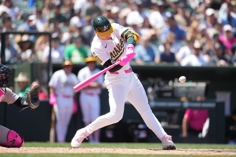 May 11, 2025; West Sacramento, California, USA; Athletics designated hitter Brent Rooker (25) hits a single against the New York Yankees in the fourth inning at Sutter Health Park. Mandatory Credit: Cary Edmondson-Imagn Images
