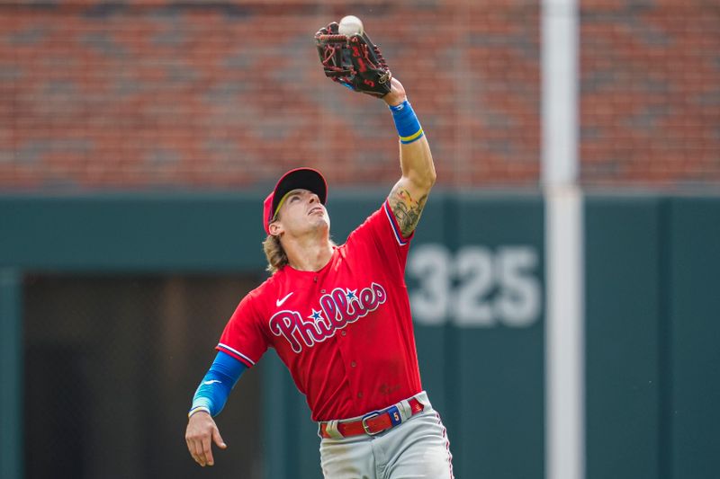 Sep 20, 2023; Cumberland, Georgia, USA; Philadelphia Phillies second baseman Bryson Stott (5) catches a pop up hit by Atlanta Braves third baseman Austin Riley (27) (not shown) for the final out during the tenth inning  at Truist Park. Mandatory Credit: Dale Zanine-USA TODAY Sports