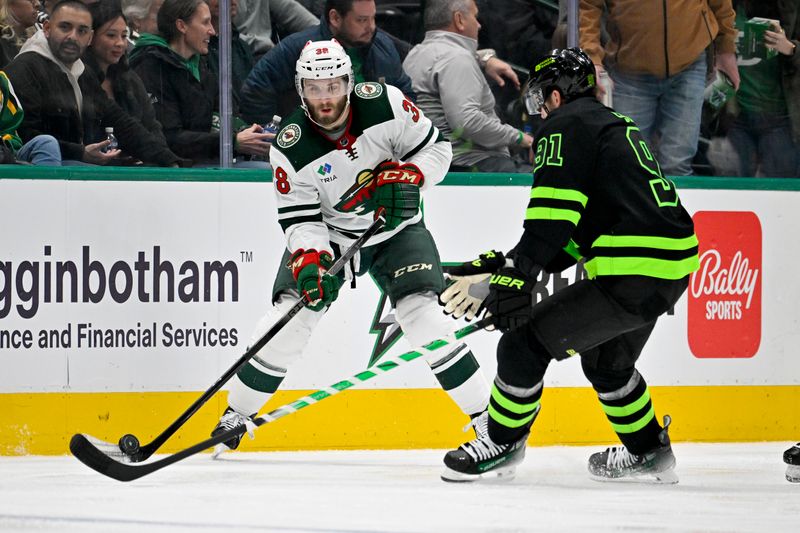 Jan 10, 2024; Dallas, Texas, USA; Minnesota Wild right wing Ryan Hartman (38) skates with the puck past Dallas Stars center Tyler Seguin (91) during the third period at the American Airlines Center. Mandatory Credit: Jerome Miron-USA TODAY Sports