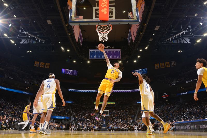 SAN FRANCISCO, CA - OCTOBER 18: Jalen Hood-Schifino #0 of the Los Angeles Lakers drives to the basket during the game against the Golden State Warriors during a NBA Preseason game on October 18, 2024 at Chase Center in San Francisco, California. NOTE TO USER: User expressly acknowledges and agrees that, by downloading and or using this photograph, user is consenting to the terms and conditions of Getty Images License Agreement. Mandatory Copyright Notice: Copyright 2024 NBAE (Photo by Noah Graham/NBAE via Getty Images)