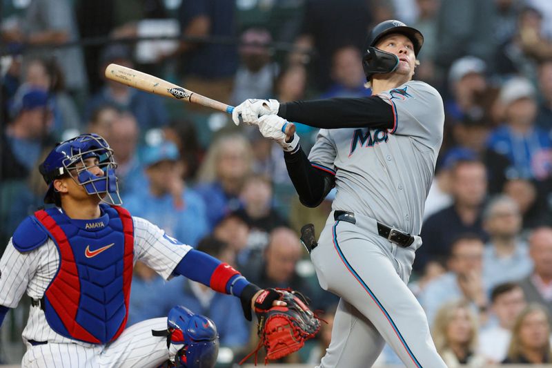 May 14, 2025; Chicago, Illinois, USA; Miami Marlins center fielder Kyle Stowers (28) hits a solo home run against the Chicago Cubs during the fourth inning at Wrigley Field. Mandatory Credit: Kamil Krzaczynski-Imagn Images