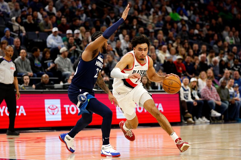 MINNEAPOLIS, MINNESOTA - MARCH 04: Justin Minaya #24 of the Portland Trail Blazers dribbles the ball to the basket against Monte Morris #23 of the Minnesota Timberwolves in the second quarter at Target Center on March 04, 2024 in Minneapolis, Minnesota. NOTE TO USER: User expressly acknowledges and agrees that, by downloading and or using this photograph, User is consenting to the terms and conditions of the Getty Images License Agreement. (Photo by David Berding/Getty Images)