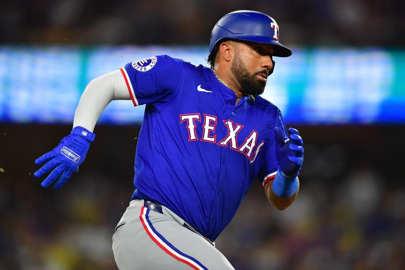 Jun 12, 2024; Los Angeles, California, USA; Texas Rangers third baseman Ezequiel Duran (20) runs after hitting a double against the Los Angeles Dodgers during the sixth inning at Dodger Stadium. Mandatory Credit: Gary A. Vasquez-USA TODAY Sports
