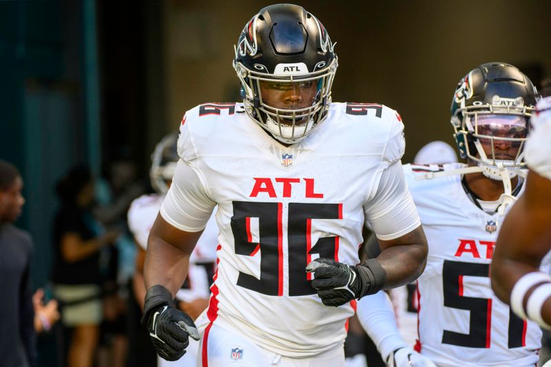 Atlanta Falcons defensive lineman Zach Harrison (96) runs onto the field before an NFL pre-season football game against the Miami Dolphins, Friday, Aug. 11, 2023, in Miami Gardens, Fla. (AP Photo/Doug Murray)