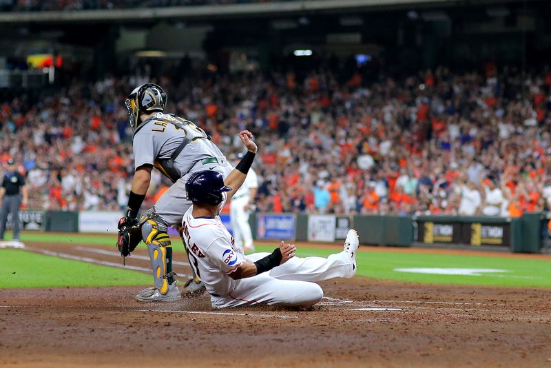 Sep 13, 2023; Houston, Texas, USA; Houston Astros designated hitter Michael Brantley (23) slides across home plate to score a run against the Oakland Athletics during the fifth inning at Minute Maid Park. Mandatory Credit: Erik Williams-USA TODAY Sports