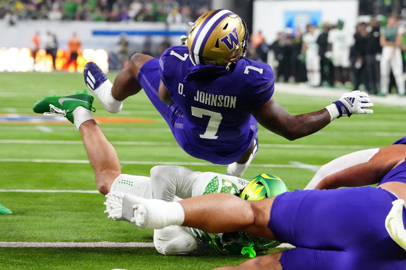 Dec 1, 2023; Las Vegas, NV, USA; Washington Huskies running back Dillon Johnson (7) scores a touchdown against the Oregon Ducks during the first quarter at Allegiant Stadium. Mandatory Credit: Stephen R. Sylvanie-USA TODAY Sports