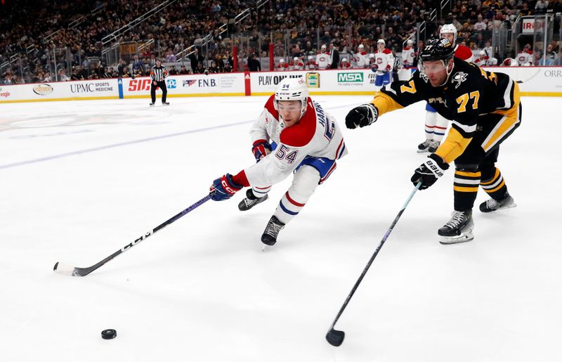 Feb 22, 2024; Pittsburgh, Pennsylvania, USA; Montreal Canadiens defenseman Jordan Harris (54) reaches for a loose puck Pittsburgh Penguins center Jeff Carter (77)  during the second period against at PPG Paints Arena. The Penguins won 4-1.Mandatory Credit: Charles LeClaire-USA TODAY Sports