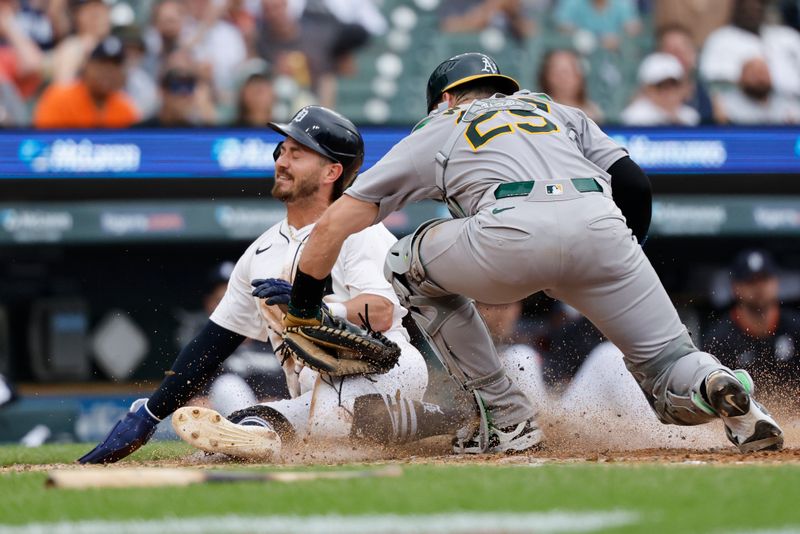 Jun 26, 2025; Detroit, Michigan, USA;  Detroit Tigers outfielder Zach McKinstry (39) is tagged out at home by Athletics catcher Austin Wynns (29) in the sixth inning at Comerica Park. Mandatory Credit: Rick Osentoski-Imagn Images