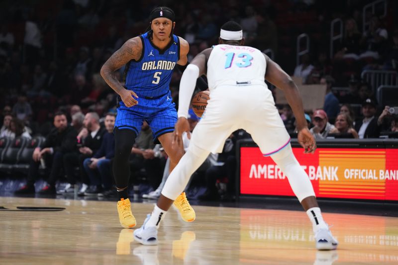 MIAMI, FLORIDA - JANUARY 27: Paolo Banchero #5 of the Orlando Magic dribbles the ball against Bam Adebayo #13 of the Miami Heat during the first quarter at Kaseya Center on January 27, 2025 in Miami, Florida. NOTE TO USER: User expressly acknowledges and agrees that, by downloading and or using this photograph, User is consenting to the terms and conditions of the Getty Images License Agreement. (Photo by Rich Storry/Getty Images)