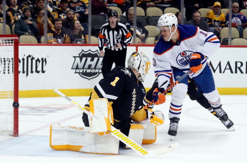 Feb 23, 2023; Pittsburgh, Pennsylvania, USA; Edmonton Oilers right wing Jesse Puljujarvi (13) hits the post behind Pittsburgh Penguins goaltender Casey DeSmith (1) during the third period at PPG Paints Arena. Edmonton won 7-2. Mandatory Credit: Charles LeClaire-USA TODAY Sports