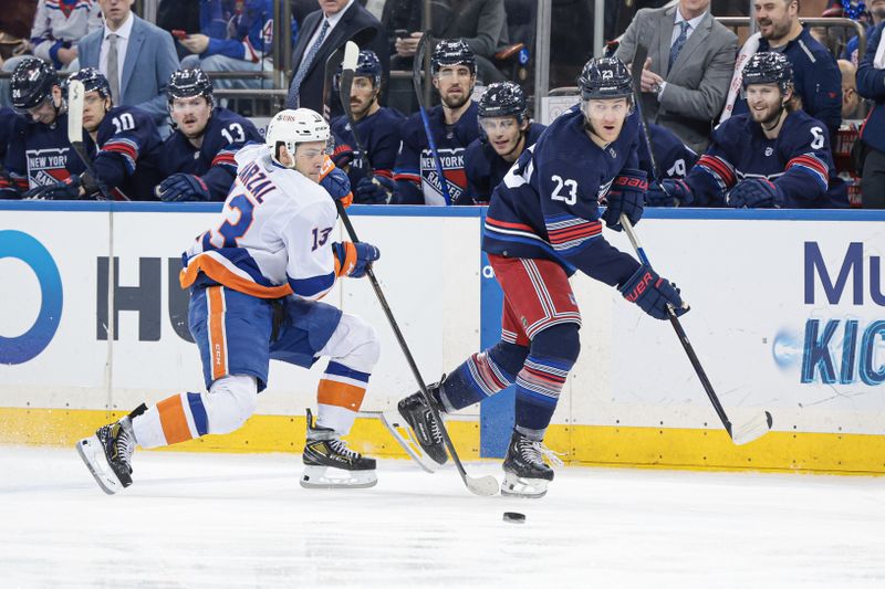 Mar 17, 2024; New York, New York, USA; New York Rangers defenseman Adam Fox (23) plays the puck against New York Islanders center Mathew Barzal (13) during the first period at Madison Square Garden. Mandatory Credit: Vincent Carchietta-USA TODAY Sports