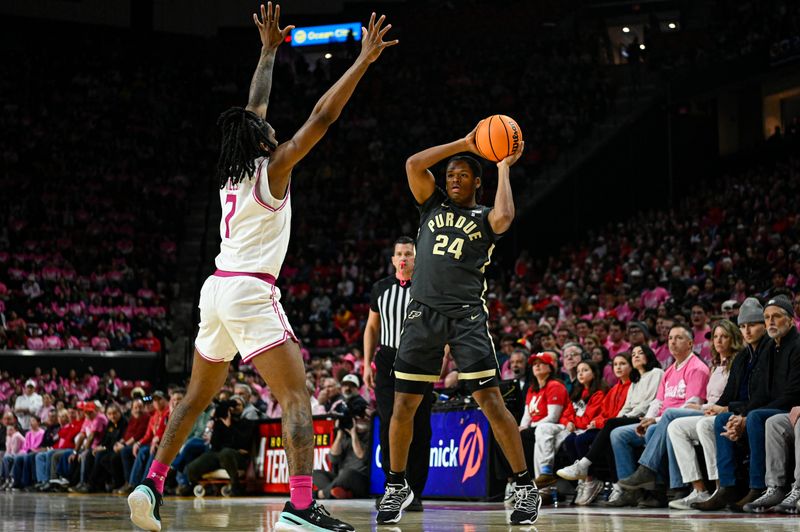 Feb 1, 2026; College Park, Maryland, USA;  Purdue Boilermakers guard Gicarri Harris (24) looks to pass as Maryland Terrapins guard Andre Mills (7) defends during the first half at Xfinity Center. Mandatory Credit: Tommy Gilligan-Imagn Images