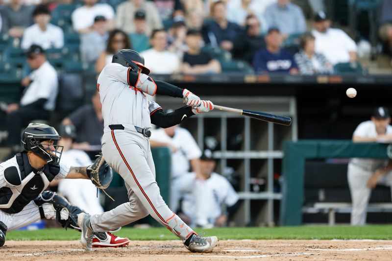 May 23, 2024; Chicago, Illinois, USA; Baltimore Orioles catcher Adley Rutschman (35) hits a RBI single against the Chicago White Sox during the third inning at Guaranteed Rate Field. Mandatory Credit: Kamil Krzaczynski-USA TODAY Sports